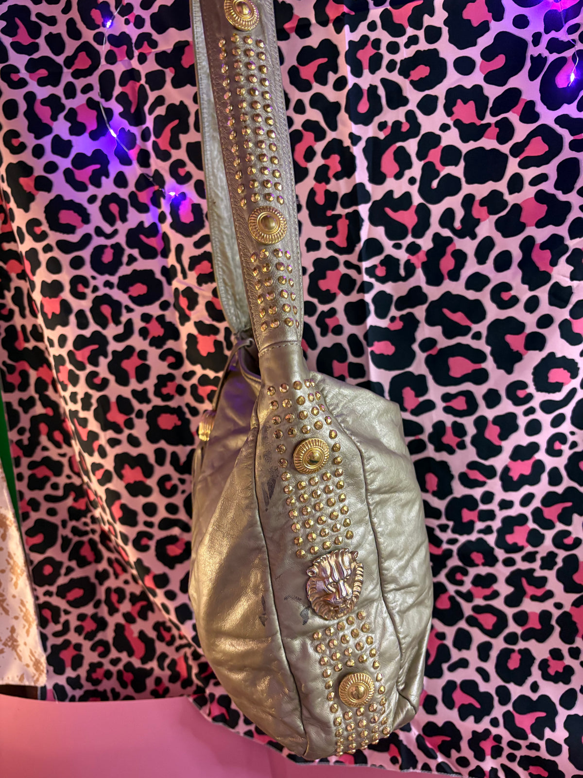 Studded fringe zipper lion head detailed metallic hobo bag